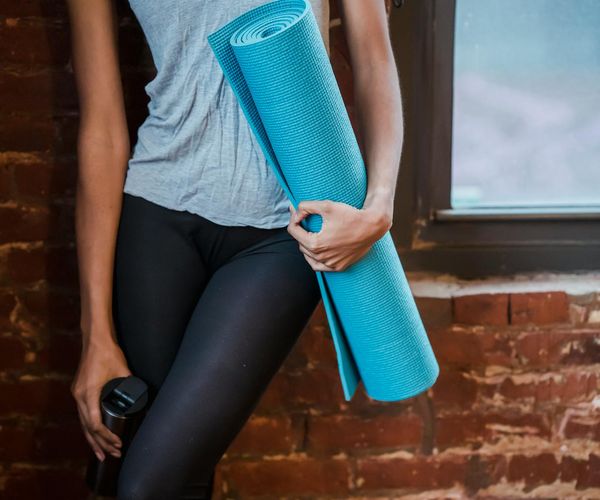 Neatly rolled yoga mat, a water bottle, and a small towel.